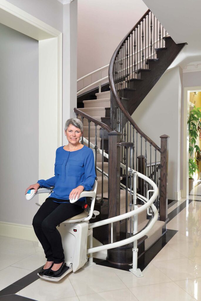 Elderly individual using a wheelchair lift for stairs safely