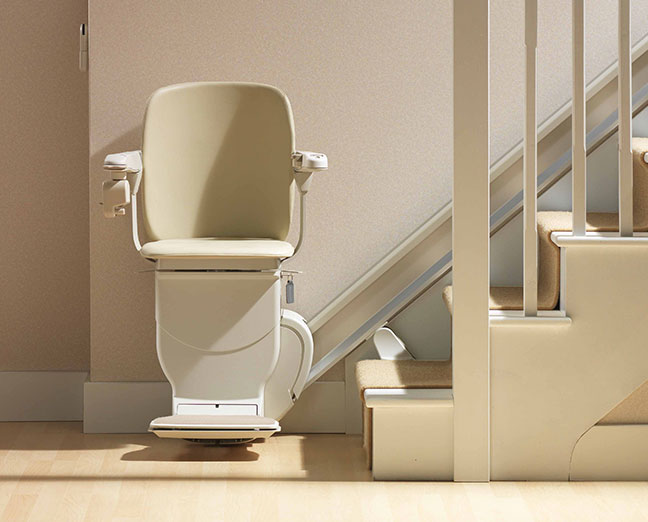 Elderly man using a chair stair elevator in a Suffolk, VA home